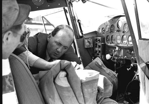 Peter Gluckman adjusting his life raft in the cockpit of his Luscombe at the USAF base in Goose Bay, Labrador in June 1953. Photo credit