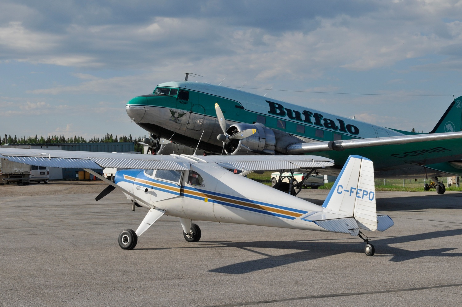 Luscombe 8F C-FEPO (formerly N1838B) Hay River. NWT, 2013. Buffalo Airways DC-3 in background. 