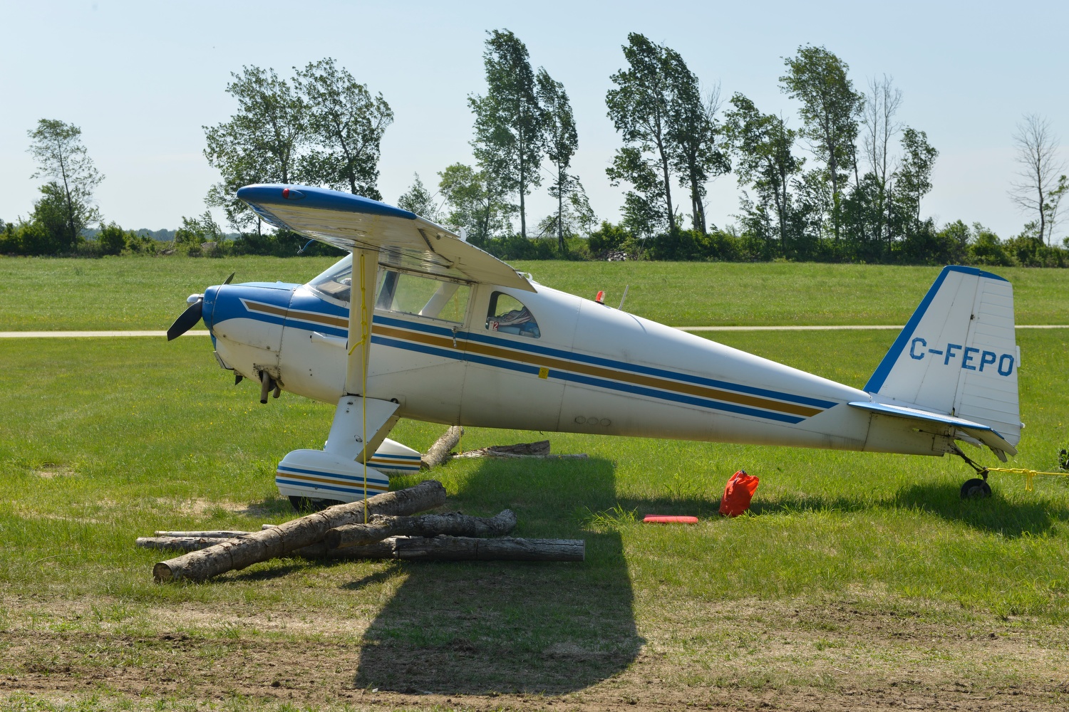 Luscombe 8F C-FEPO (formerly N1838B) St Ferdinand, Quebec. Aircraft is securely tied down in lee side of a container to protect it from high winds. 2017 