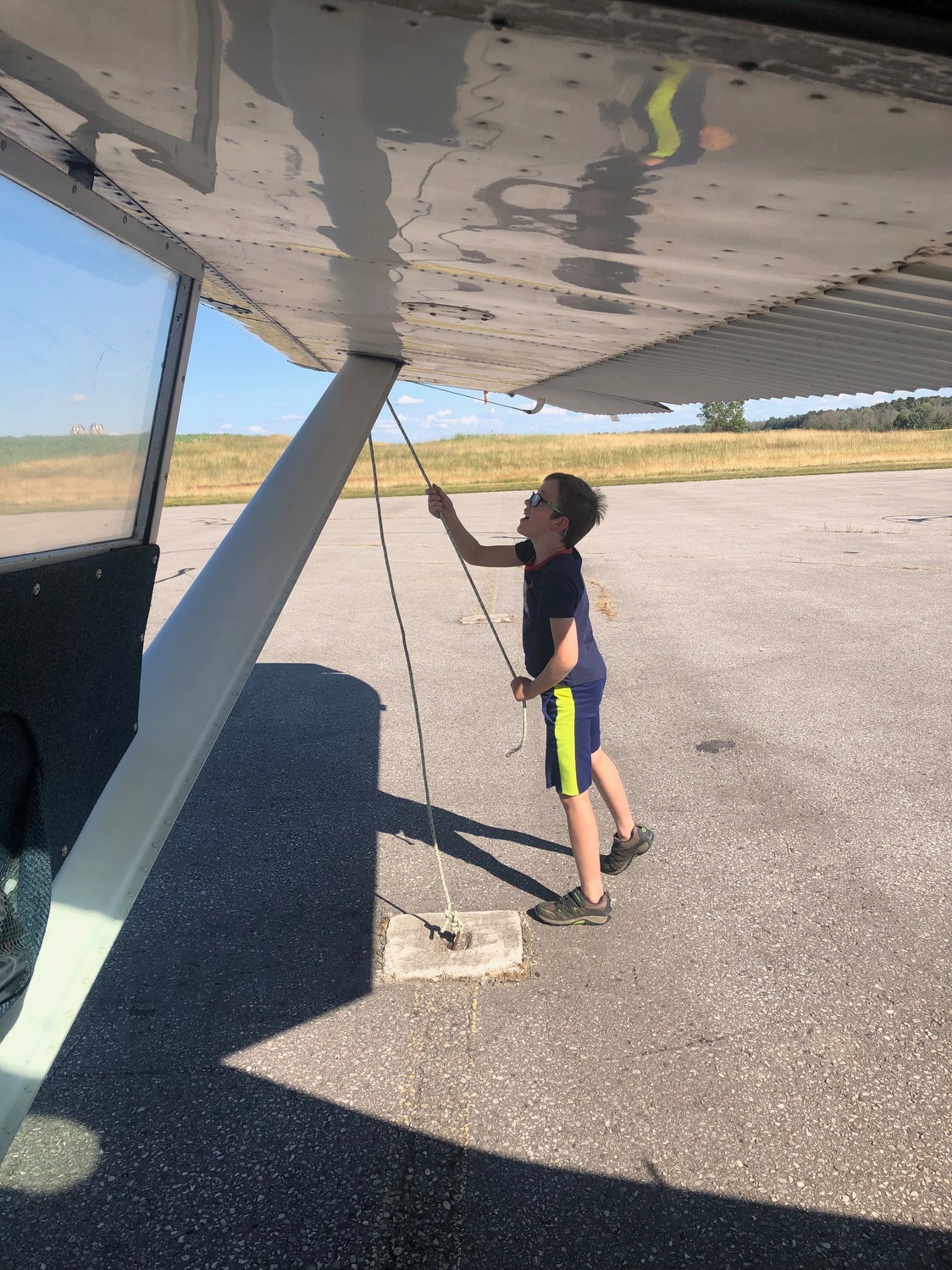 Luscombe 8F C-FEPO (formerly N1838B) Wingham, Ontario 2019. Useful co-pilot tying down aircraft.