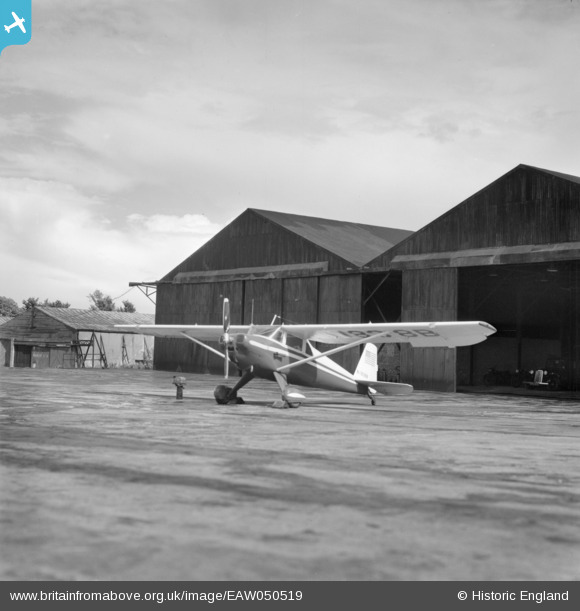 Luscombe 8 (N1838B) at Elstree Aerodrome, Aldenham near London in June 1953 (or possibly July 9, 1953). From the can standing near the aircraft it might be that Peter Gluckmann is changing the oil of his aircraft. It is unclear if this photograph was taken before or after his flight to Berlin-Tempelhof. Photographer unknown. britainfromabove.org.uk/en/image/EAW050519