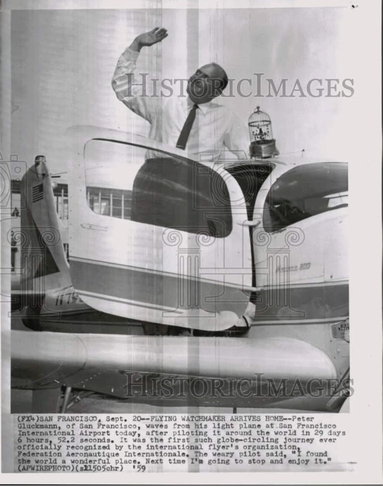 Photo Caption reads: (FX4) SAN FRANCISCO, Sept 20 — FLYING WATCHMAKER ARRIVES HOME — Peter Gluckmann, of San Francisco, waves from his light plane at San Francisco International Airport today, after piloting it around the world in 29 days, 6 hours, 52.2 seconds. It was the first such globe-circling journey ever officially recognized by the international flyer's organization, Federation Aeronautique Internationale. The weary pilot said, 'I found the world a wonderful place. Next time I'm going to stop and enjoy it.” (APWIREPHOTO). Photographer unknown. 